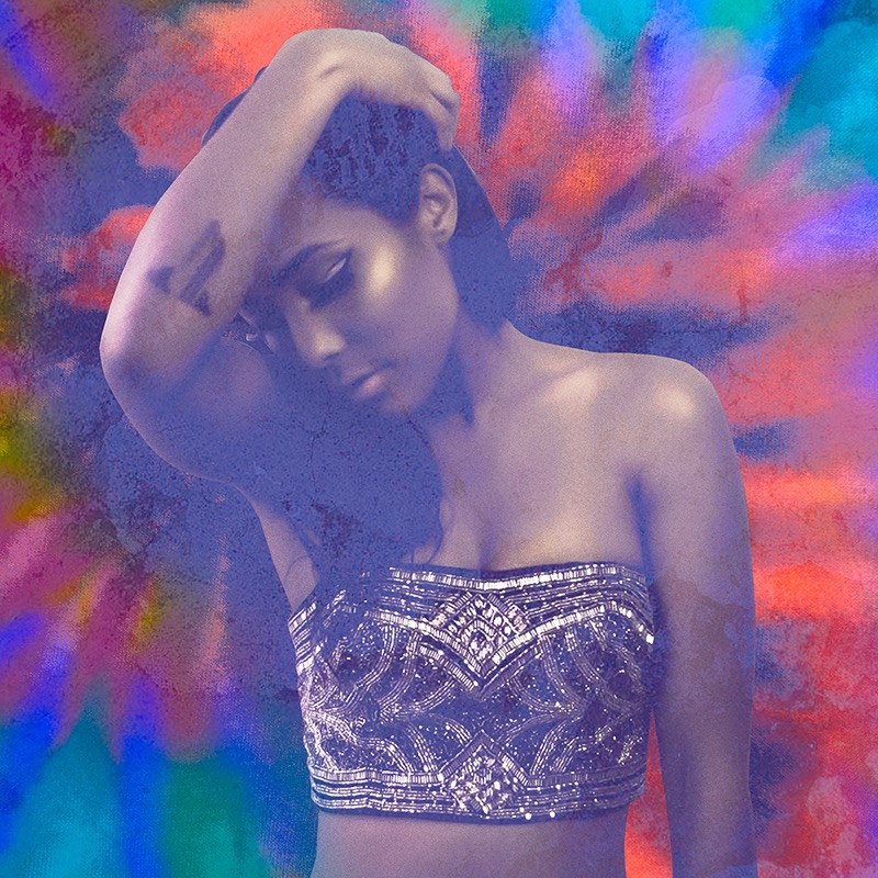 Portrait in a beaded top against a tie-dye backdrop
