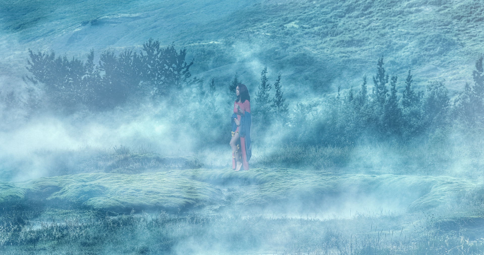 Figure in a misty highland field surrounded by soft blue haze
