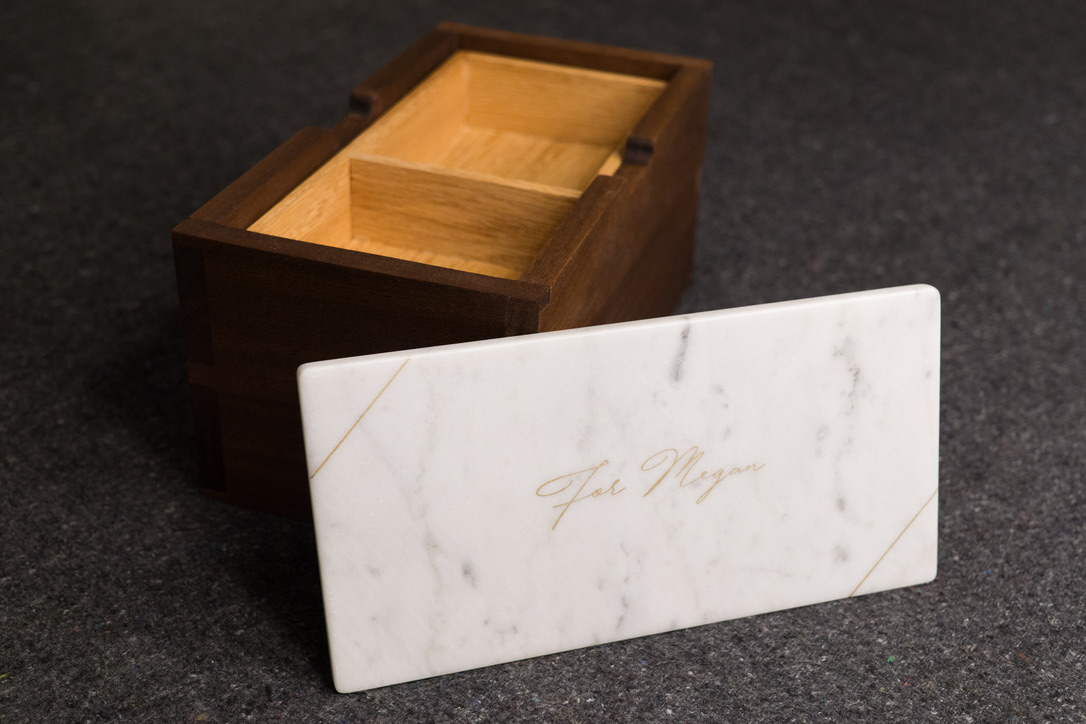 Marble lid with 'For Megan' engraving beside the open box