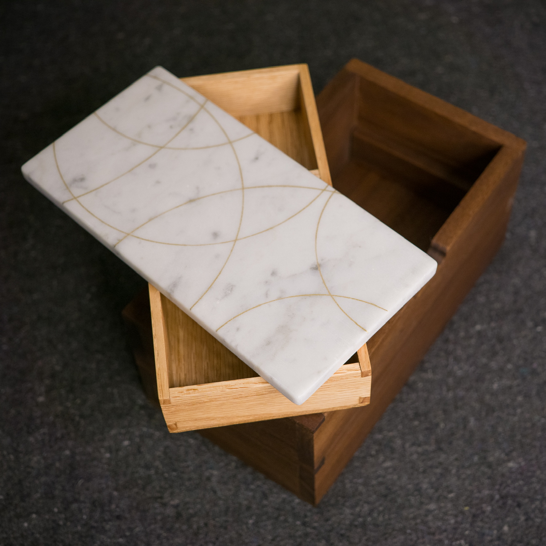 Jewelry box open showing oak interior and marble lid
