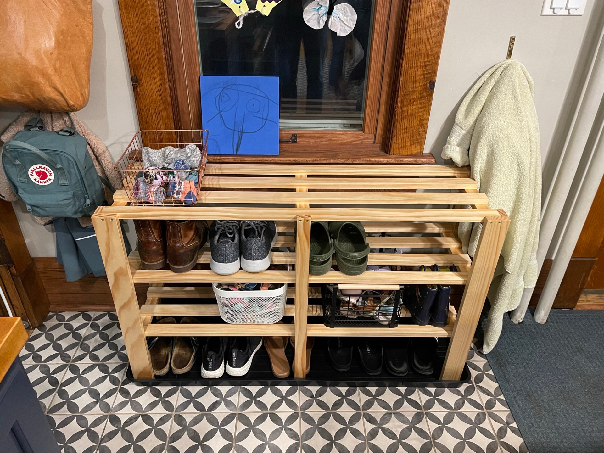 Slatted wooden entryway shoe rack