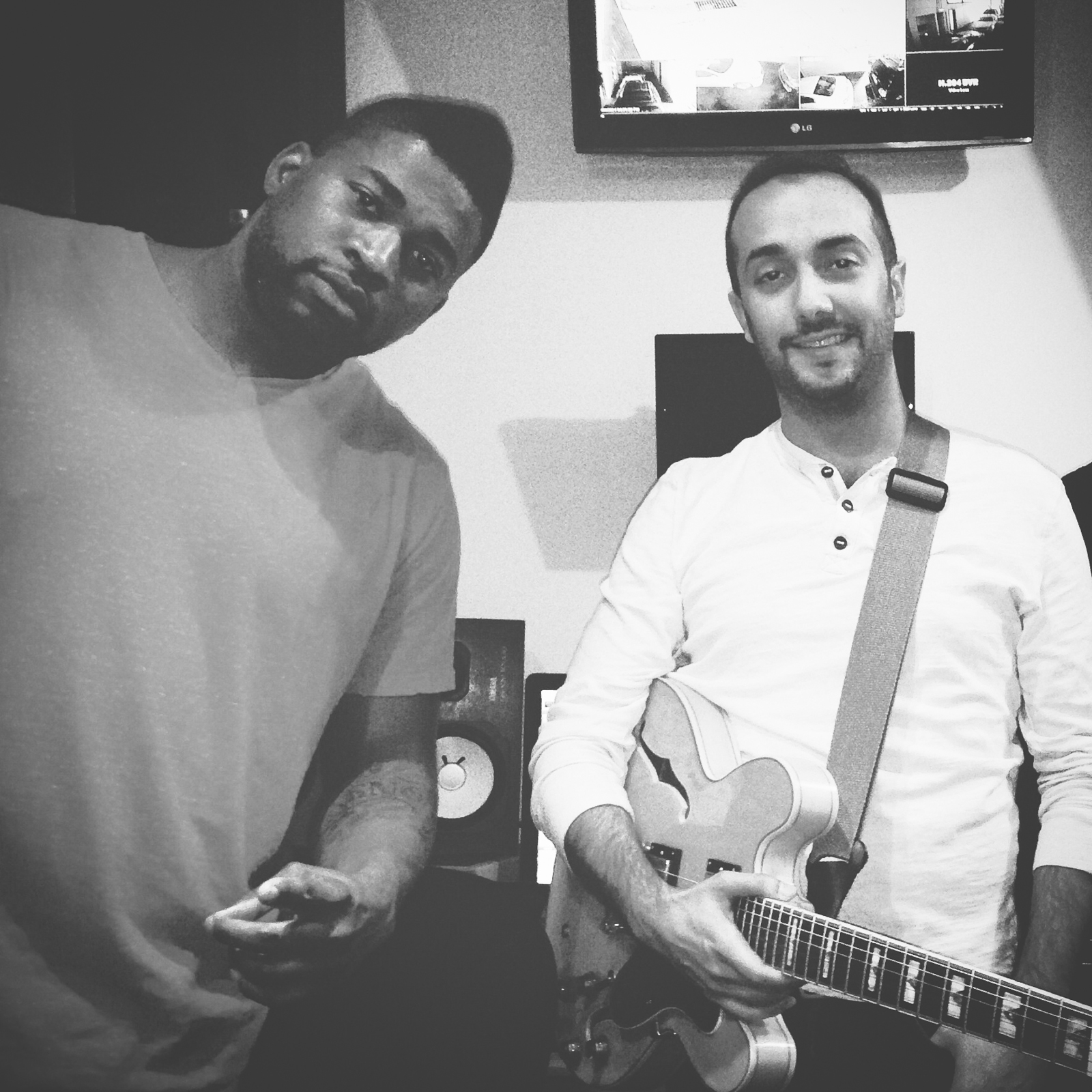 In the studio recording with a collaborating guitarist