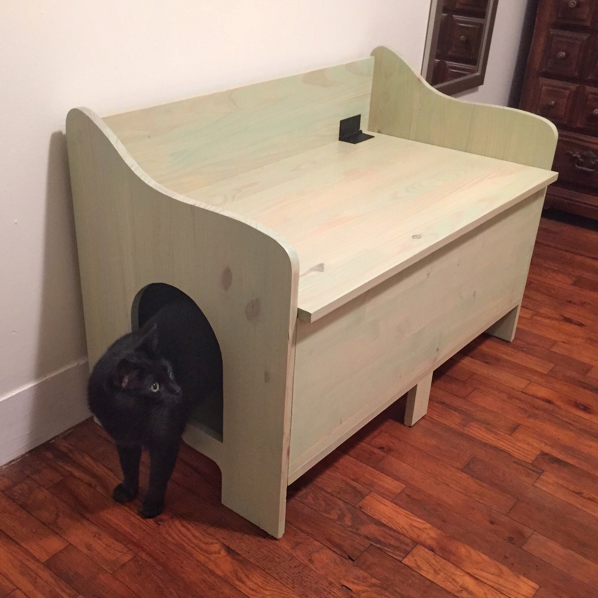 Wooden litter box bench with a cat stepping out