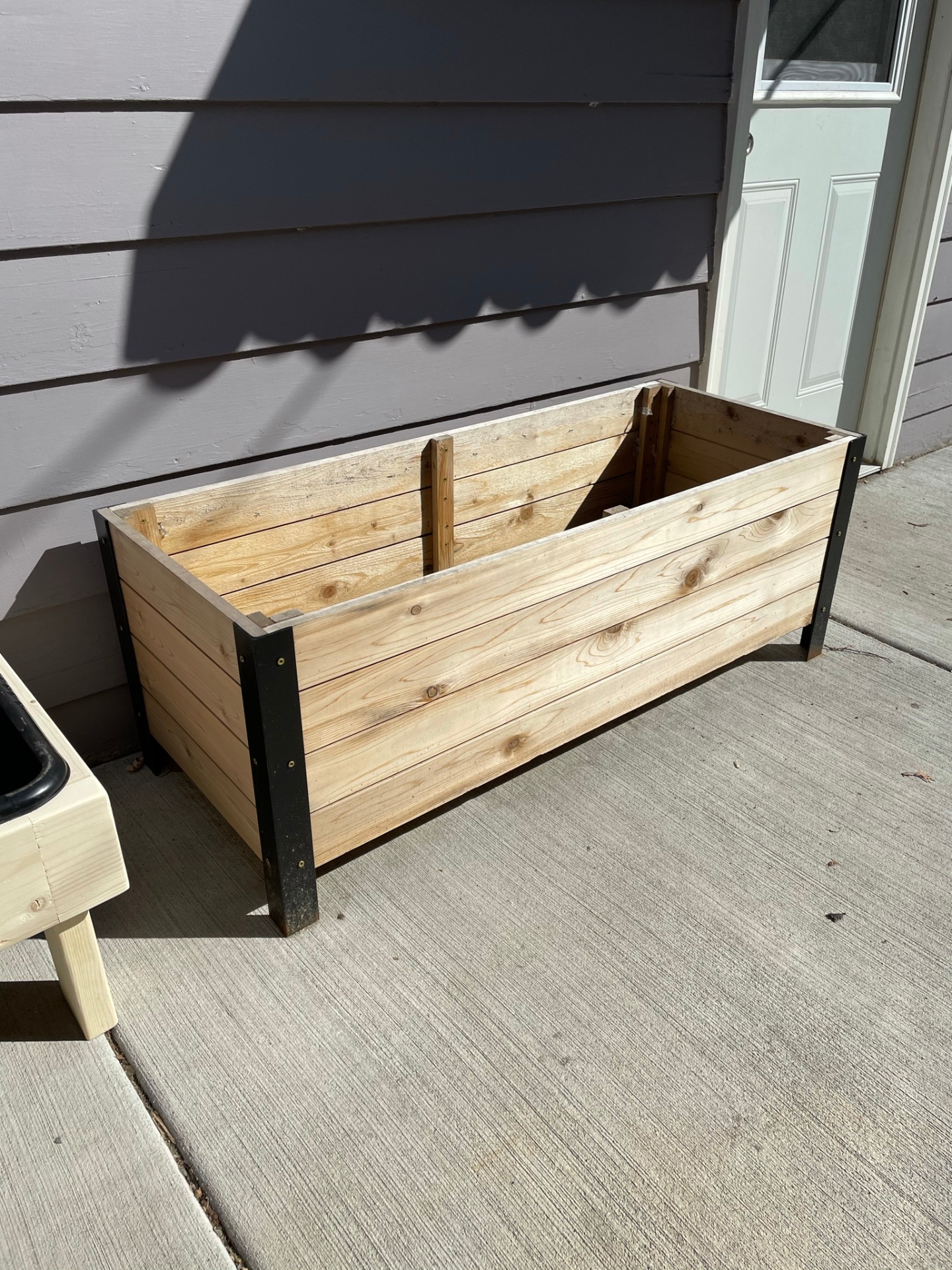 Cedar and steel raised planter box on the patio
